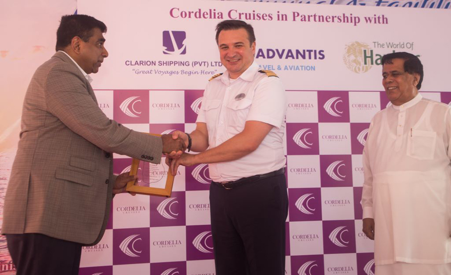 Minister of Ports Shipping and Aviation Nimal Siripala De Silva right with Advantis Group Managing Director Ruwan Waidyaratne left and Captain of MS Empress Denis Korop center at the plaque exchange ceremony